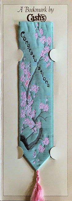 J & J Cash woven bookmark, with title words and image of pink flower spray