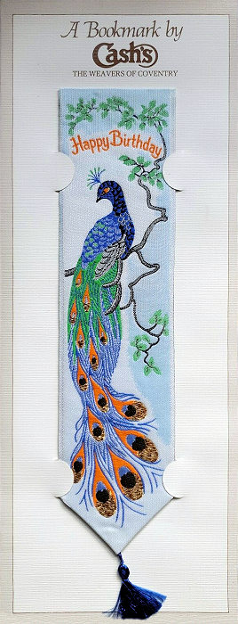 Cash's woven bookmark with woven title words and image of a peacock