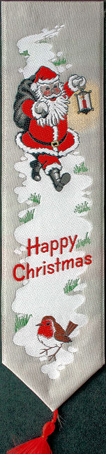 Cash's woven bookmark, with title words and image of Father Christmas holding a lantern