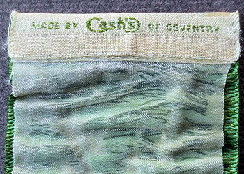 J & J Cash logo woven on reverse top turnover of this bookmark