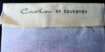 J & J Cash woven logo on the reverse top turnover of this bookmark