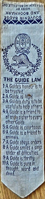 Cash's woven bookmark with woven words of the Guide's Laws