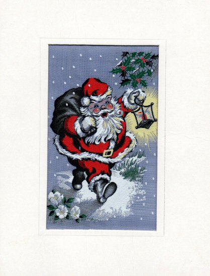 J & J Cash woven Christmas card, with no words, with image of Father Christmas carrying a candle lantern, with holly and white flower decoration