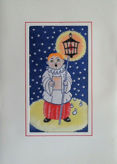 J & J Cash woven Christmas card, with no words, but image of a Carol singer holding a lantern on a pole