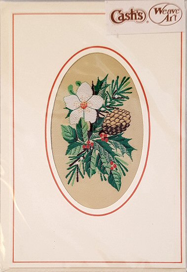 J & J Cash woven Christmas card, with no words, but image of White flower, fir cone & holly