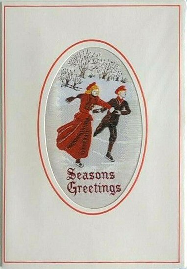 J & J Cash woven Christmas card, with SEASONS GREETINGS words, and image of two skaters