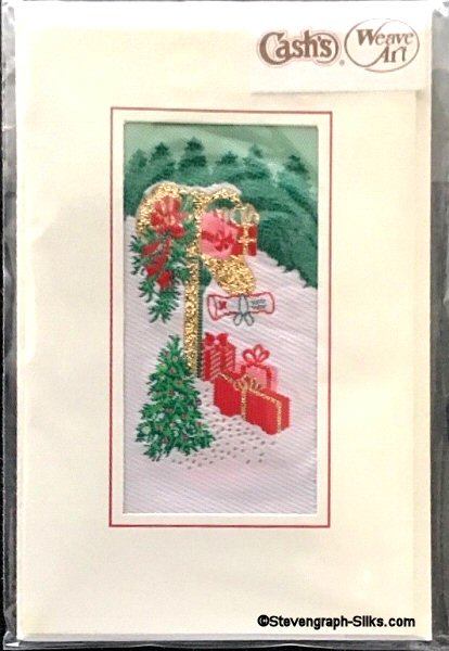 J & J Cash woven Christmas card, with no words, but image of Gifts in snow next to a mail box