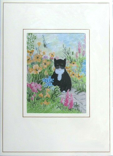 J & J Cash woven card, with no words, but picture of a Black Cat sitting in a flower garden