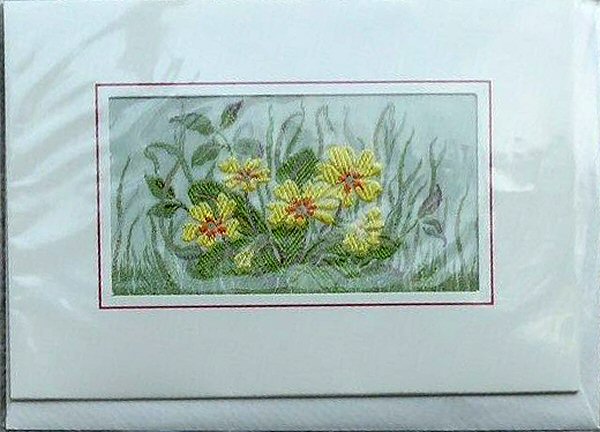 J & J Cash woven landscape flower card, with image of five Primrose flowers)