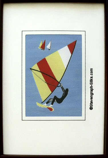 J & J Cash woven sports card, with image of a windsurfer with multicoloured sail