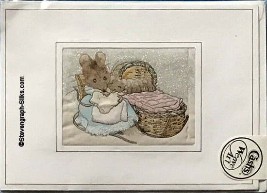 J & J Cash woven card, with no title words, but image of Hunca Munca next to a babies cradle