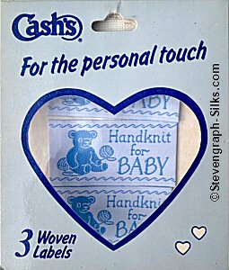 J & J Cash woven saw-on label with words: HANDKNIT FOR BABY