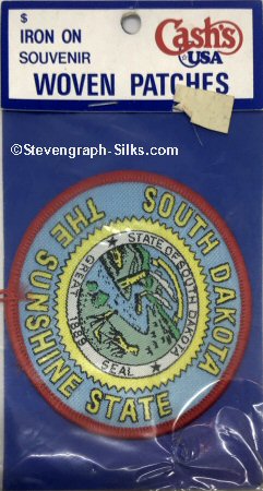 J & J Cash woven saw-on label with words: South Dakota The Sunshine State