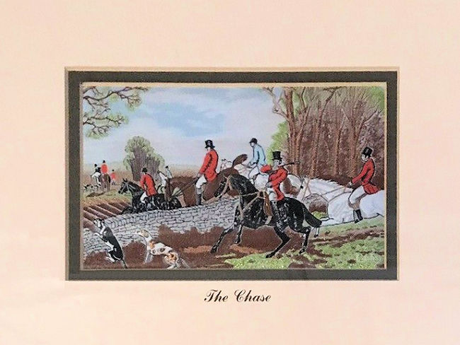 J & J Cash woven picture with image of horses and riders jumping over a stone wall