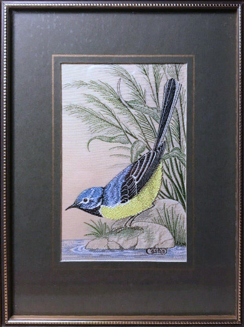J & J Cash woven picture of a bird, with no words, but image of a Grey Wagtail
