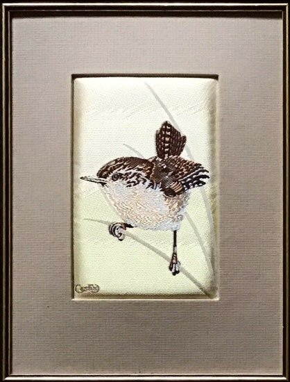 J & J Cash woven picture of a bird, with no words, but image of a Wren balancing on a thin twig