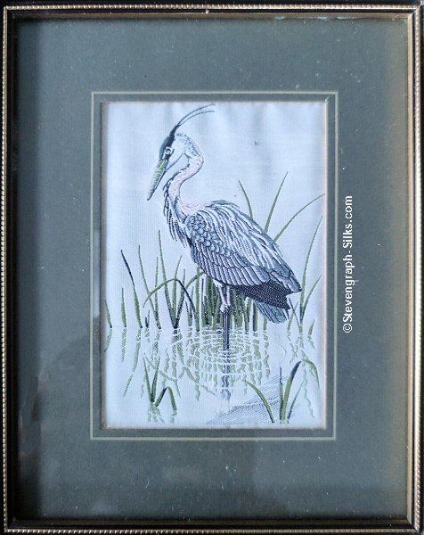 J & J Cash woven picture of a bird, with no words, but image of a Heron looking left