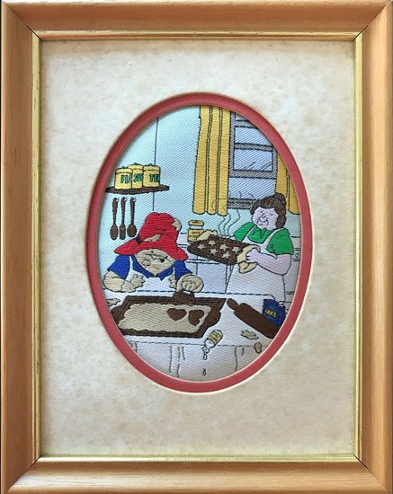 J & J Cash small oval centred woven picture with image of Paddington Bear baking biscuits