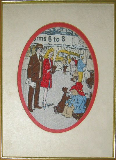 J & J Cash small oval centred woven picture with image of Paddington Bear at Paddington station, platform 6 to 8