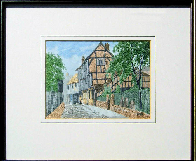 J & J Cash woven scenic picture of an old world street with wood framed building