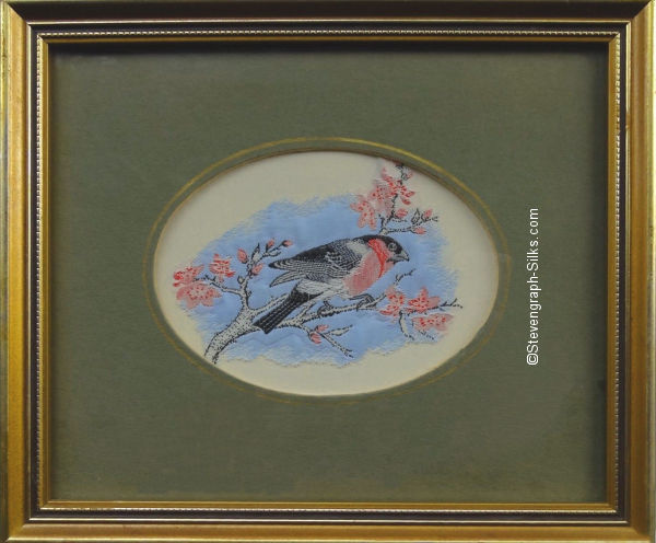 Framed woven picture of a bullfinch perched on a branch