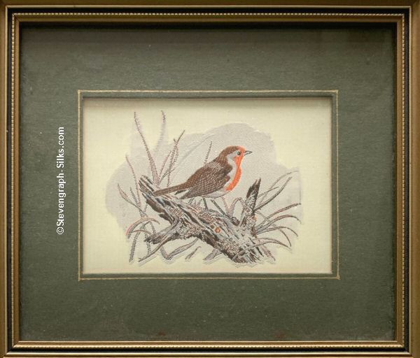 Framed woven picture of a robin perched on a tree trunk