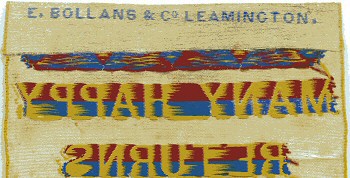 Bollans name woven on the top turn-over of this bookmark