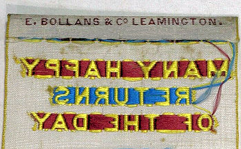 Bollans name woven on the top turn-over of this bookmark