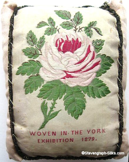 pin cushion with words " Woven in the York Exhibition 1879 "