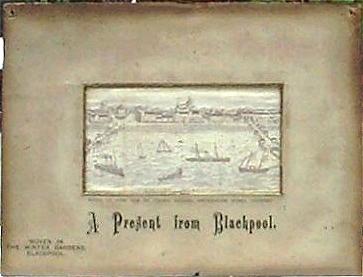 Image of Blackpool, bounded by two piers, with various craft in the sea.