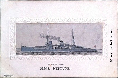 Naval ship at anchor, with heavy guns on the superstructure