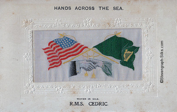 woven image of USA and Irish flags, with man's and woman's hands, but with man's hand having five fingers plus a thumb.