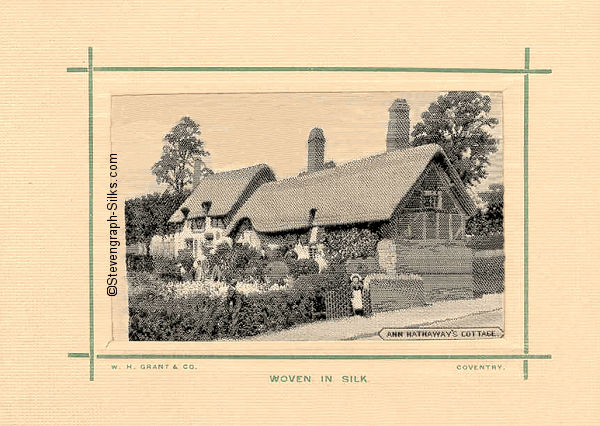 black and white silk picture of thatched cottage, mounted on card with green border