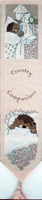 Cash's woven bookmark with woven title words, and image of a hedgehog in bed