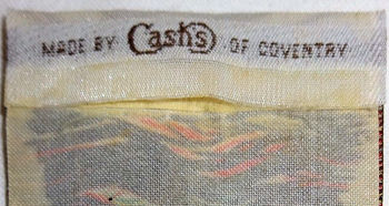 J & J Cash woven logo on the reverse top turnover of this bookmark