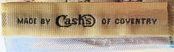 woven J & J Cash name on reverse top turnover of this bookmark