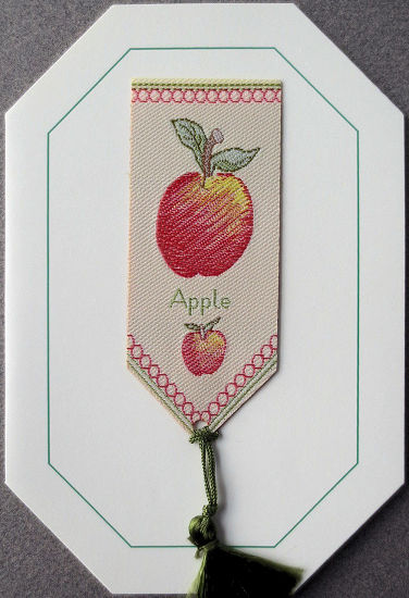 Cash's greeting card, with an attached woven bookmark titled: APPLE