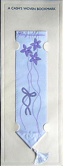 J & J Cash woven bookmark, with title words and image of mauve flowers