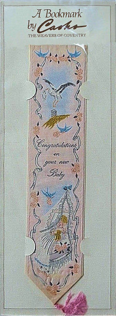 J & J Cash woven bookmark, with title words and image of a stork & baby's cradle