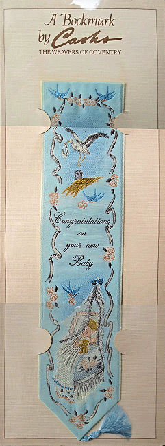 J & J Cash woven bookmark, with title words and image of a stork & baby's cradle