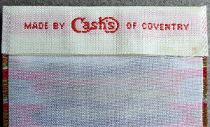 J & J Cash woven name and logo on the reverse top turn over of this bookmark