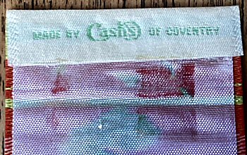 Cash's name woven on the reverse top turnover of this bookmark