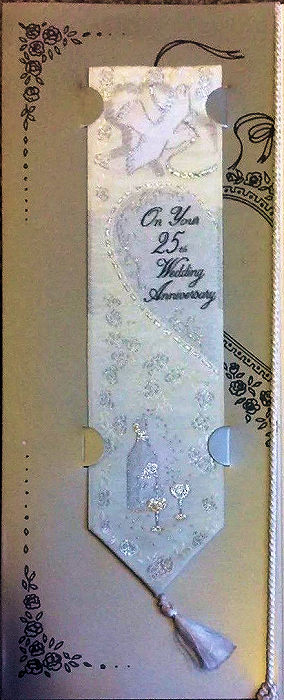 J & J Cash woven bookmark, with title words, image of a dove and champagne bottle and glasses