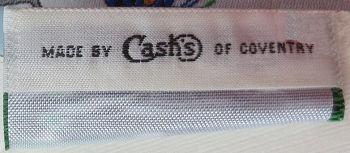woven J & J Cash name on reverse top turnover of this bookmark