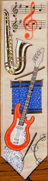 J & J Cash woven bookmark, with no words, but images of guitar and other musical instruments