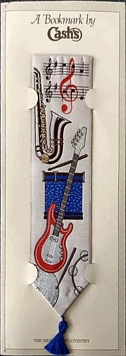 J & J Cash woven bookmark, with no words, but images of guitar and other musical instruments