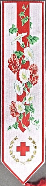 J & J Cash woven bookmark, with no words, just images of red and white flowers, and an image of a red cross