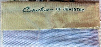 J & J Cash woven name on the reverse top turnover of this bookmark