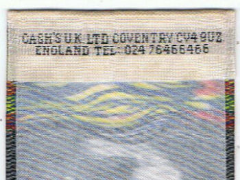 J & J Cash woven logo on the reverse top turnover of this bookmark