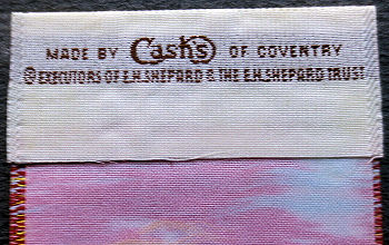 woven J & J Cash name on reverse top turnover of this bookmark